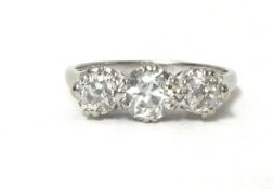 An 18ct white gold three stone diamond ring, claw set with old cut stones weighing approximately 0.