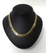18ct rose gold curb style fringe necklet with oval and circular droplets having a box snap clasp and