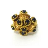 An 18k gold and sapphire abstract cluster ring, the stones naturalistically set in a bark design,