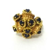 An 18k gold and sapphire abstract cluster ring, the stones naturalistically set in a bark design,