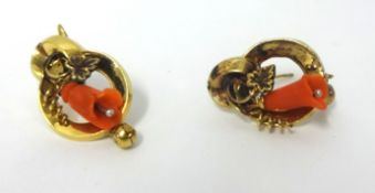 A Victorian pair of gold and coral earrings, of floral scroll design, weight 3.9 grams.