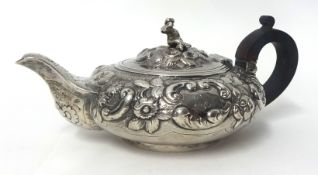 A George IV silver bachelor tea pot, by T.B, London 1824, with embossed floral and shell decoration,