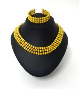 Ilias Lalaounis; An 18ct gold collar and bangle, composed of three rows of uniform textured