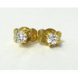 A pair of 18ct gold and diamond ear studs, claw set with brilliant cut stones of approximately 0.