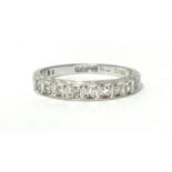 An 18ct white gold and diamond half eternity ring, box set with nine single cut stones, size N 1/2.