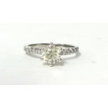 A 14k single stone diamond ring, raised claw set with a brilliant cut stone estimated to weigh 0.