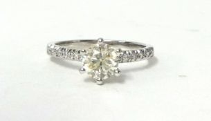 A 14k single stone diamond ring, raised claw set with a brilliant cut stone estimated to weigh 0.