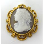 A Victorian gold and hardstone cameo brooch, circa 1870, depicting a classical lady in profile, to a