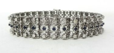 An 18ct white gold, sapphire and diamond bracelet, claw set with three rows of sapphires and