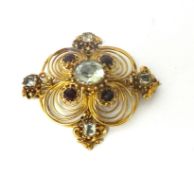 A Victorian gold, aquamarine and garnet brooch, the central mixed cut stone within an openwork
