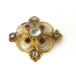 A Victorian gold, aquamarine and garnet brooch, the central mixed cut stone within an openwork