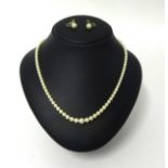 A single row cultured pearl necklace, composed of graduated beads, together with a pair of