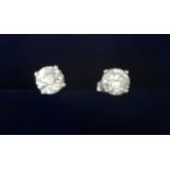 A pair of 14ct white gold and diamond single stone earstuds, claw set with brilliant cut stones