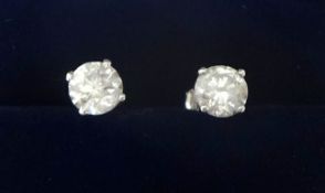 A pair of 14ct white gold and diamond single stone earstuds, claw set with brilliant cut stones