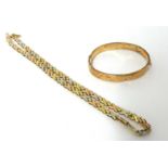 A 9ct three colour gold necklace, composed of "X" links, and a 9ct gold hinged bangle, gross