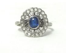 An Edwardian white metal, sapphire and diamond cluster ring, collet set with an oval mixed cut