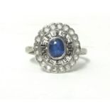 An Edwardian white metal, sapphire and diamond cluster ring, collet set with an oval mixed cut