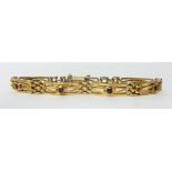 An Edwardian gold and amethyst bracelet, stamped 15ct, composed of openwork panels collet set with