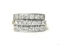 An 18ct gold and diamond panel ring, set with three rows of brilliant cut stones, total diamond