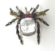 A Victorian gold, diamond, ruby and quartz spider brooch, silver set with a mixed cut quartz,