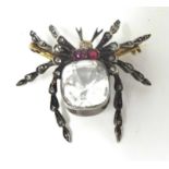 A Victorian gold, diamond, ruby and quartz spider brooch, silver set with a mixed cut quartz,