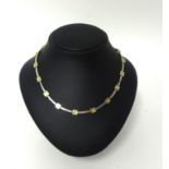 A 9ct two colour gold necklace, composed of square and baton links, weight 18 grams.