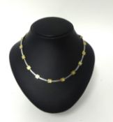 A 9ct two colour gold necklace, composed of square and baton links, weight 18 grams.