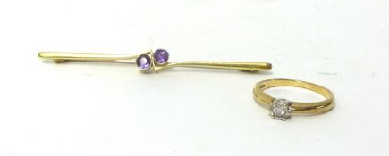 An Edwardian 15ct gold amethyst set twist bar brooch, and a single stone diamond ring.
