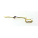 An Edwardian 15ct gold amethyst set twist bar brooch, and a single stone diamond ring.