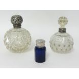 An Edwardian silver mounted, cut glass mounted scent bottle, Birmingham 1911, and two other scent