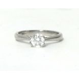 A platinum and diamond single stone ring, claw set with a brilliant cut stone weighing 0.44cts,