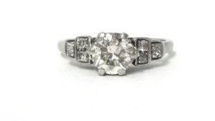 A platinum and diamond single stone ring, claw set with a brilliant cut stone weighing approximately