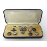 A silver gentlemans dress set, composed of circular abalone shell panels, cased.