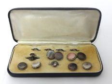A silver gentlemans dress set, composed of circular abalone shell panels, cased.