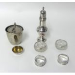A silver sugar castor, Birmingham 1933, of baluster form, two silver napkin rings and three salt