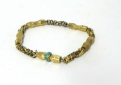 An early Victorian gold bracelet, composed of alternate engraved panels and twist links, turquoise