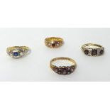 A Victorian 15ct gold almandine garnet and half pearl dress ring, a sapphire and diamond three stone