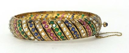 A multi-gemset hinged bangle, set with alternate rows of lasque diamonds, sapphires, pearls,