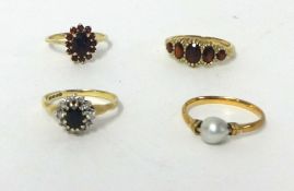A 9ct gold garnet cluster ring, finger size L 1/2, a 9ct gold five stone garnet ring and two dress
