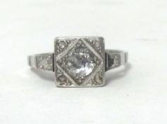 A single stone white metal and diamond ring, box set with an old cut stone with rose cuts to the