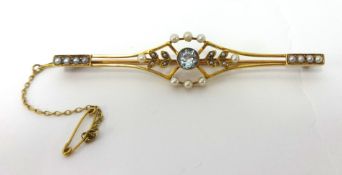An Edwardian aquamarine and pearl bar brooch, the central collet set mixed cut aquamarine within