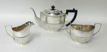 An electroplated three piece tea service, of oval half fluted form.