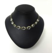 A silver set colourless quartz collar necklace, collet set with graduated stones.