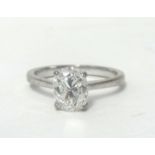An 18ct white gold single stone diamond ring, claw set with an oval cut diamond weighing