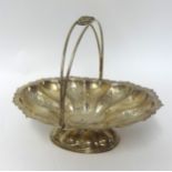 An Edwardian silver swing handle basket, Birmingham 1902, of oval lobed form, raised on a pedestal