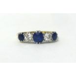 An 18ct gold sapphire and diamond five stone ring, claw set with mixed and brilliant cut stones,