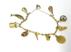 A 9ct gold charm bracelet set with various charms, weight 16.9 grams.
