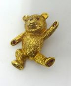 A 9ct gold and ruby Teddy Bear novelty brooch, the naturalistic body set with ruby detailing, height