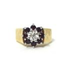 A 9ct gold garnet and diamond cluster ring, finger size N 1/2, weight 5.4 grams.