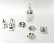 Three silver pepper pots, a silver mounted glass scent bottle and four Arabic pieces of silver,